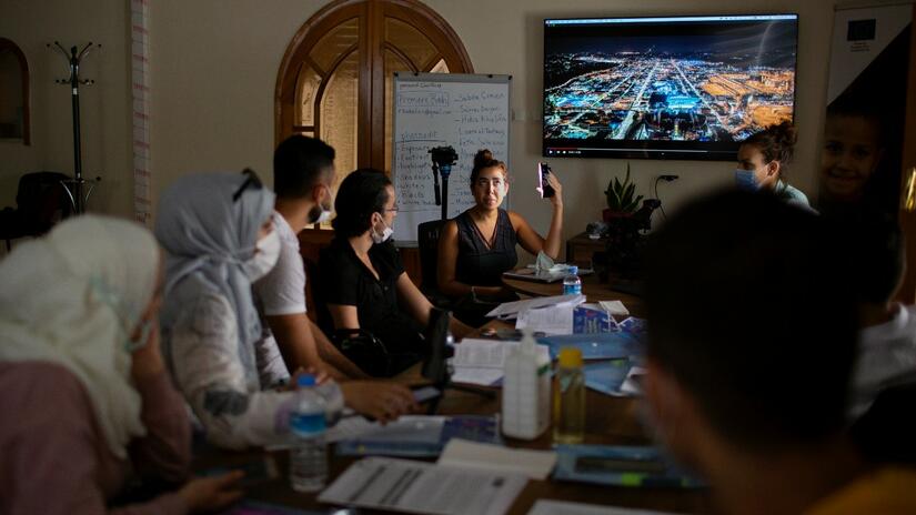 Participants of the ESSN storytelling project gather together at a workshop to learn new communications and storytelling skills