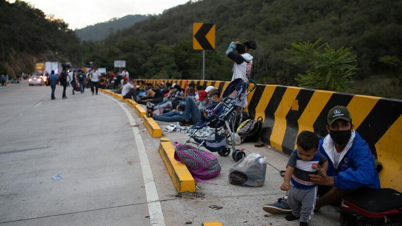 People gather on the side of the road in San Pedro Sula, Honduras as they prepare to embark upon a journey northwards through Guatemala and beyond in search of a better life. 