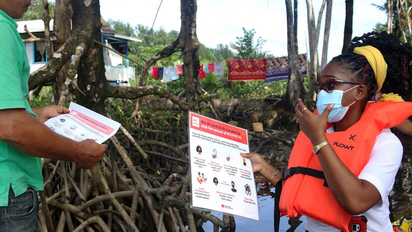 Personnel from the Guyana Red Cross delivers information on COVID-19 infection, prevention and vaccines to hard-to-reach riverside communities
