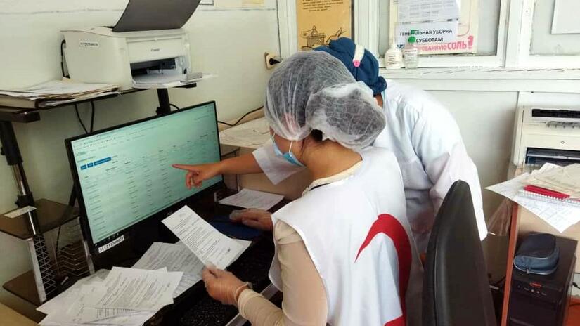 Kyrgyzstan Red Crescent volunteers help manage patient records as part of their efforts supporting the national rollout of COVID-19 vaccines