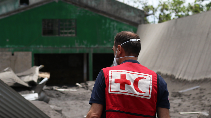 An IFRC team member observes damages to a building caused by ashfall from the La Soufrière volcano eruption in St. Vincent and the Grenadines in 2021