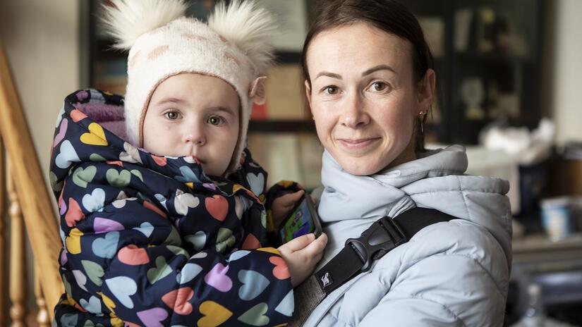 Olana and her daughter Anastasia pick up a bag of relief supplies from a Polish Red Cross branch