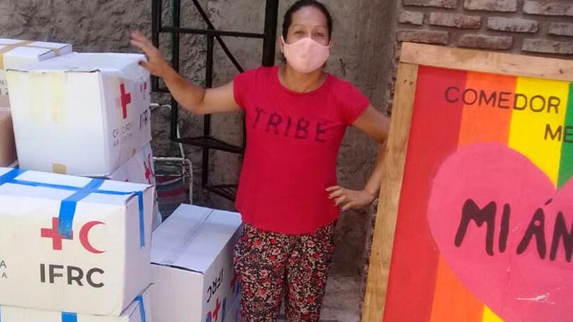 A friendly Argentine Red Cross volunteer hands out menstrual hygiene supplies as part of a special project to support the menstrual health needs of transgender people who may otherwise struggle to get a hold of suitable supplies