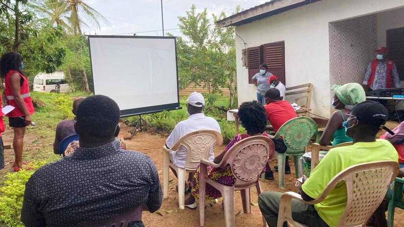 People in the community of Afan Mabé in the southern region of Cameroon attend a mobile cinema screening and watch a short film about how to stay safe from cholera.