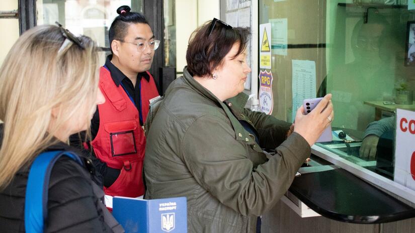 Svitlana, a Ukrainian refugee currently residing in Romania, visits a local MoneyGram branch in Bucharest in April 2022 to collect cash provided through the IFRC's cash assistance programme for people affected by the conflict.