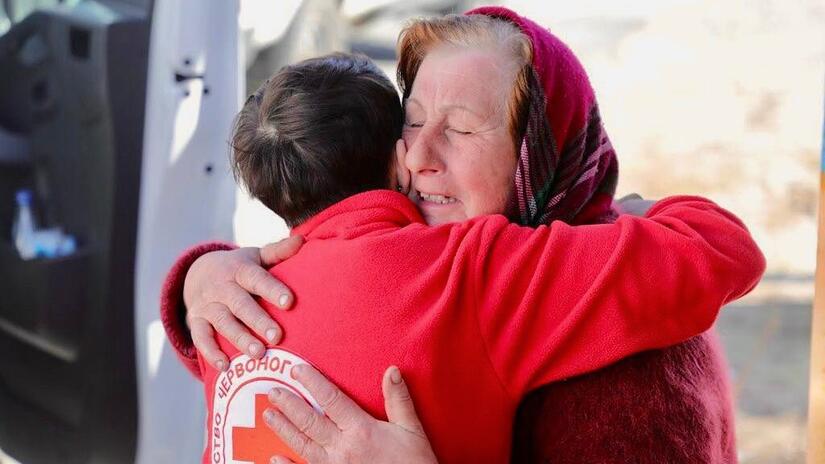  A volunteer hugs a woman affected by the conflict in Ukraine and reassures her she will receive help and assistance from the Ukrainian Red Cross.