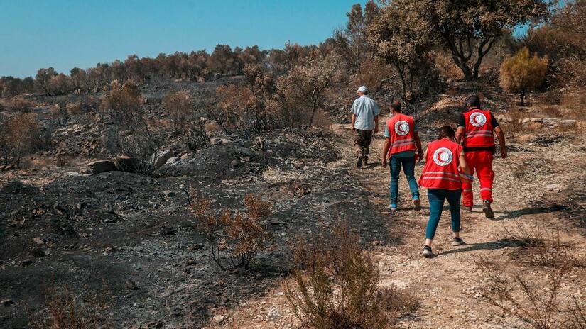 Syrian Arab Red Crescent volunteers survey the land after large wildfires in western Syria, in the Governorates of Tartus and Latakia. The local media reports that more than 20,000 families have been affected by the fires and more than 140 villages are partly or fully burnt.