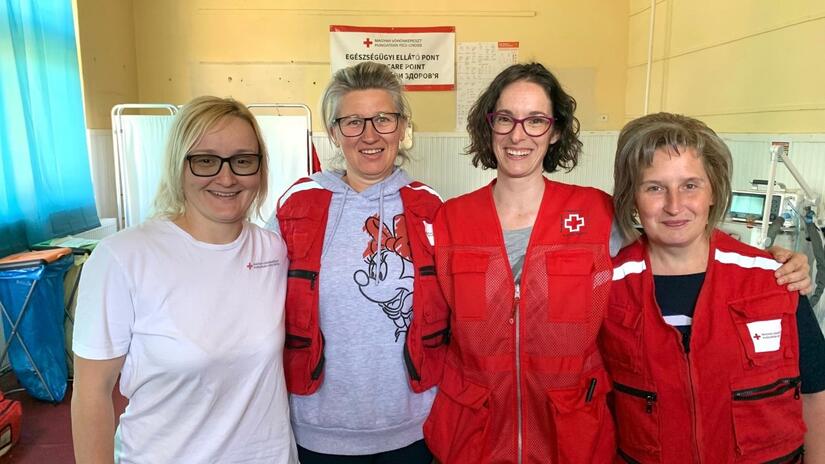 Ana Blanco from the Spanish Red Cross stands with three members of the Hungarian Red Cross team working hard on the border with Ukraine to support people fleeing the conflict