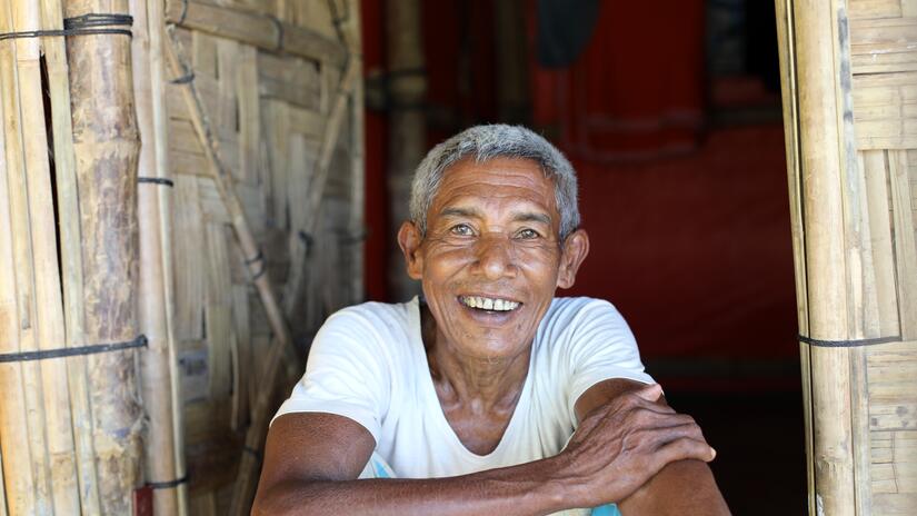 A man, Abdur Shafi, 54, sits at his new shelter from the Bangladesh Red Crescent