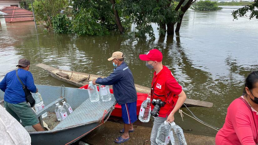 Thai Red Cross personnel prepare to distribute relief to households that are stuck in stagnant flood waters