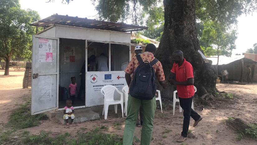 A man arrives at information kiosk in Salikenie, Senegal - part of the Kolda Humanitarian Service Point where people on the move can access assistance on their journeys