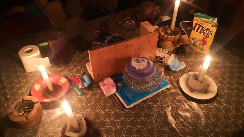 Four candles on a table provide a small amount of heat and light to Sonia and Jose Antonio, a couple living in a makeshift shelter in Alcalá, Spain.