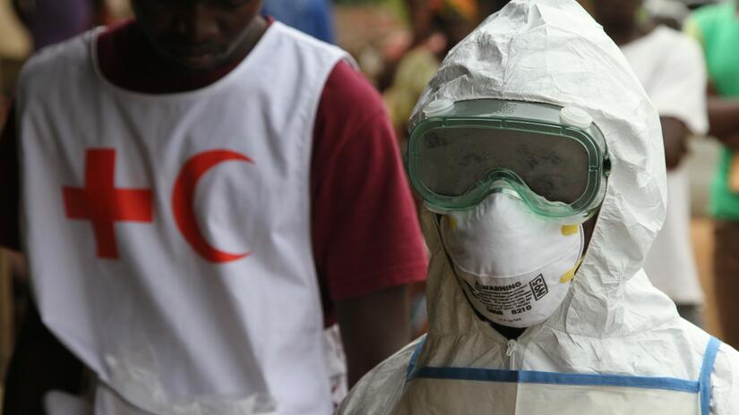 A Sierra Leone Red Cross volunteer dons personal protective equipment to help people during the Ebola outbreak in West Africa in 2014.