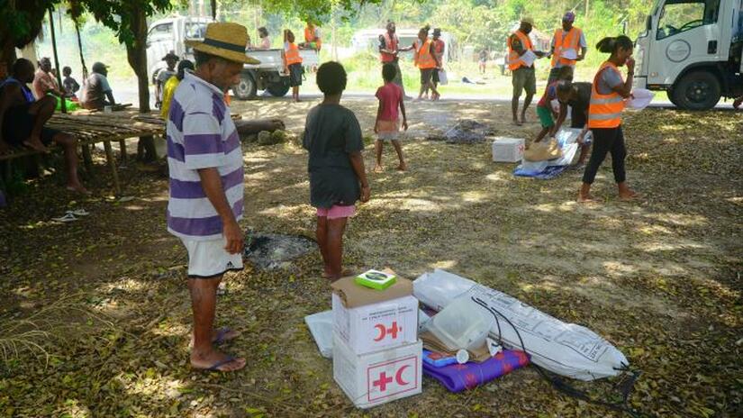 Lulu Vuti, 53, from North Efate receives relief items from Vanuatu Red Cross volunteers after double cyclones devastated his community.