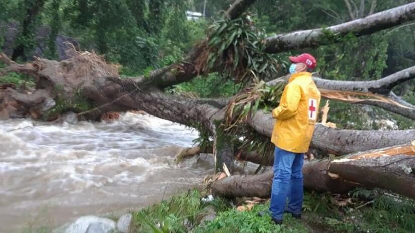 Honduran Red Cross volunteer, Napoleón, inspects damage caused by Hurricanes Eta and Iota in Honduras in November 2020 and plans how to cross flood waters to reach affected communities with humanitarian assistance.