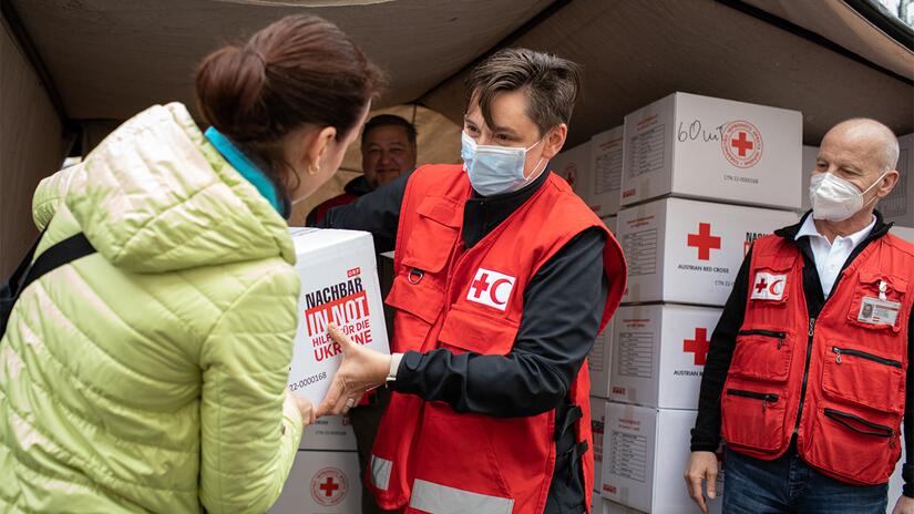 IFRC staff hand out hygiene kits provided by the Austrian Red Cross to people on the move fleeing conflict in Ukraine.