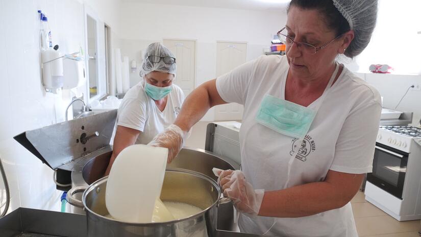 Tünde gets involved and helps to make cheese in the factory set up by the Hungarian Red Cross.