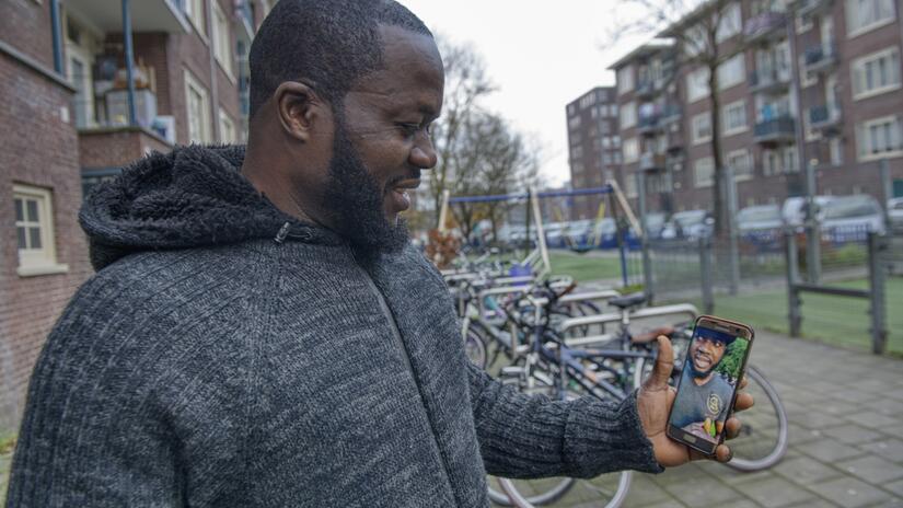 Izzy in Amsterdam video calls his friend back in Sierra Leone during COVID-19.