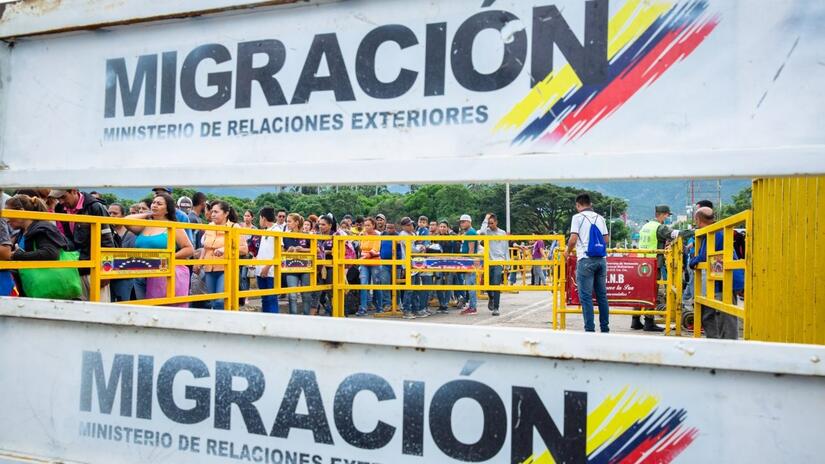 People on the move from Venezuela wait in line at the Colombian border.