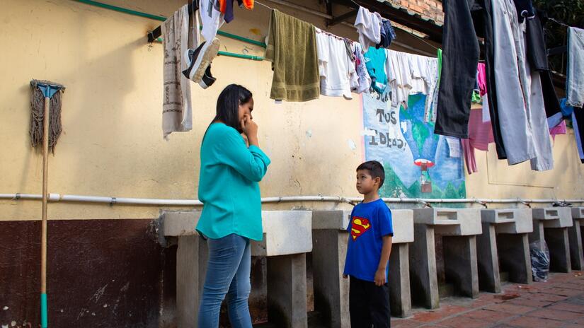 Samuel and his mother, Emily, from Venezuela wait in a Colombian Red Cross shelter near Cucuta before embarking on their journey to Medellin.