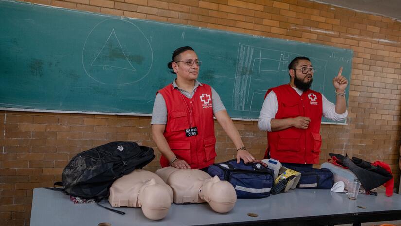 Two Mexican Red Cross volunteers teach first aid and CPR to detainees in a prison in Mexico City.