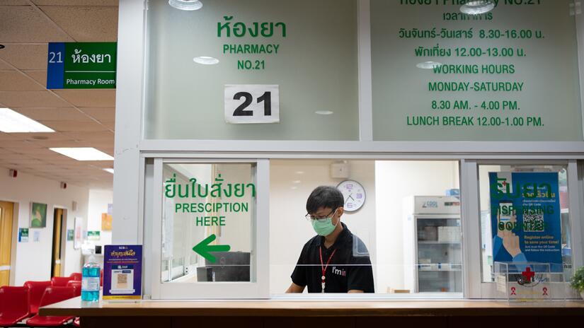 A health worker sits at the reception desk of the Anonymous Clinic to greet transgender people coming in seeking support.