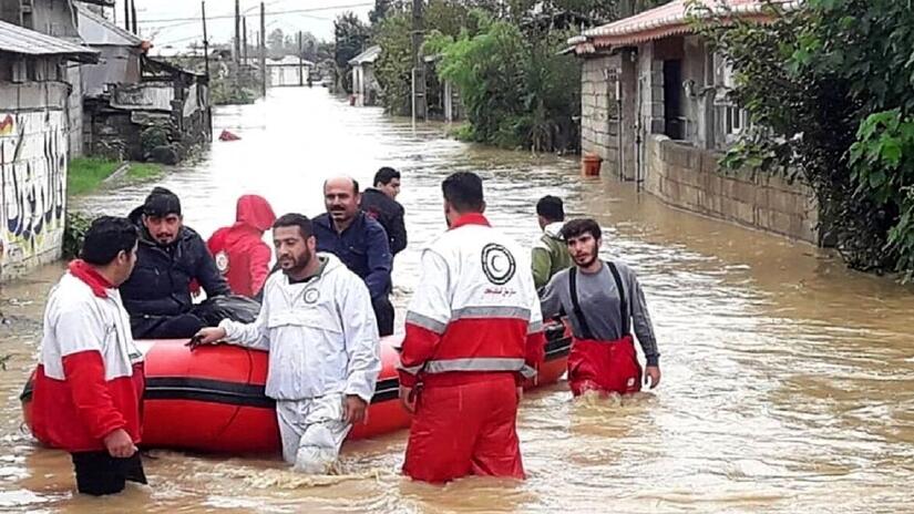 Iranian Red Crescent Society volunteers rescue people stranded by flood waters in early August 2023.