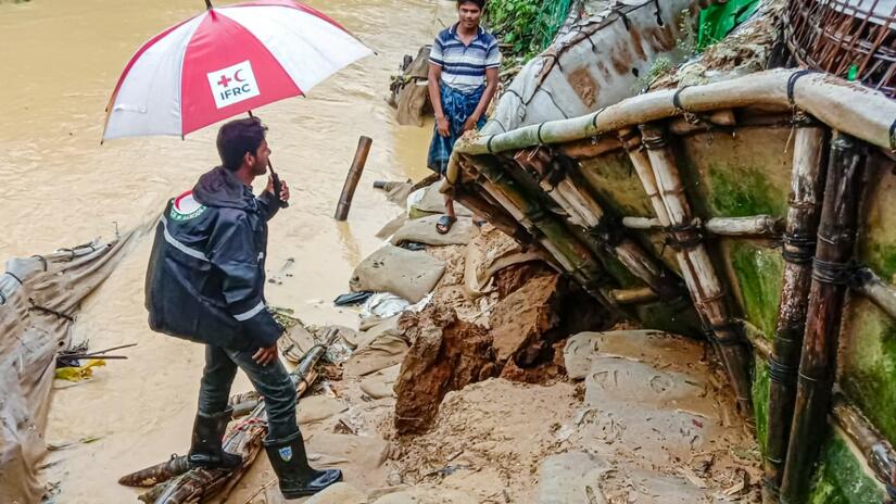 In August 2023, Bangladesh Red Crescent volunteer assesses the aftermath of torrential rains in Cox's Bazar — where landslides and floods have left a trail of destruction and loss.