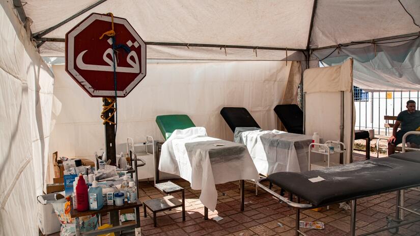 A look inside one of the makeshift hospital wards set up in the streets of Amizmiz following the September 8 earthquake. A street sign stands next to a table of medical supplies.
