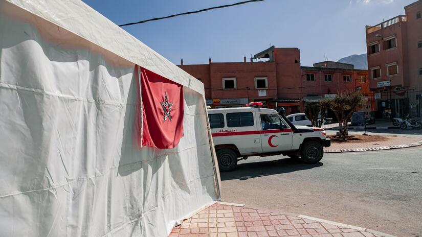A Moroccan Red Crescent vehicle is parked up outside hospital tents in Amizmiz village, Morocco.