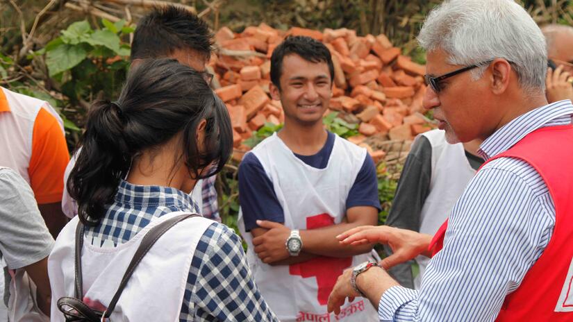 IFRC Secretary General, Jagan Chapagain, talks to young Nepal Red Cross volunteers during a visit to Nepal.