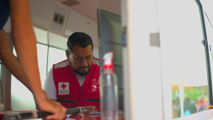 Leonardo Baca provides medical attention inside the mobile unit of the Humanitarian Service Point.