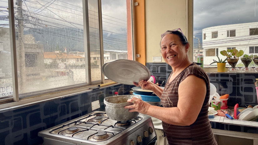 Belkis Colmenares smiles to the camera from her kitchen. She was one of the migrants that received cash assistance from Ecuadorian Red Cross to cover basic needs such as food, rent and medicines.  