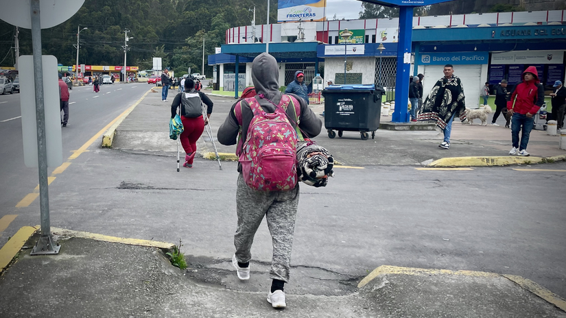 Walking with the help of two crutches, Cristia is accompanied by her husband Winston, who walks behind her.