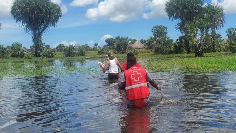 Kenya Red Cross volunteers wade in to help communities stranded by recent flooding.
