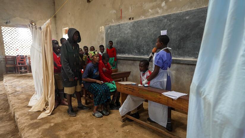 School Health Club members in Mwisi school, Uganda put on a performance in their school hall to teach fellow students about different diseases and health threats.