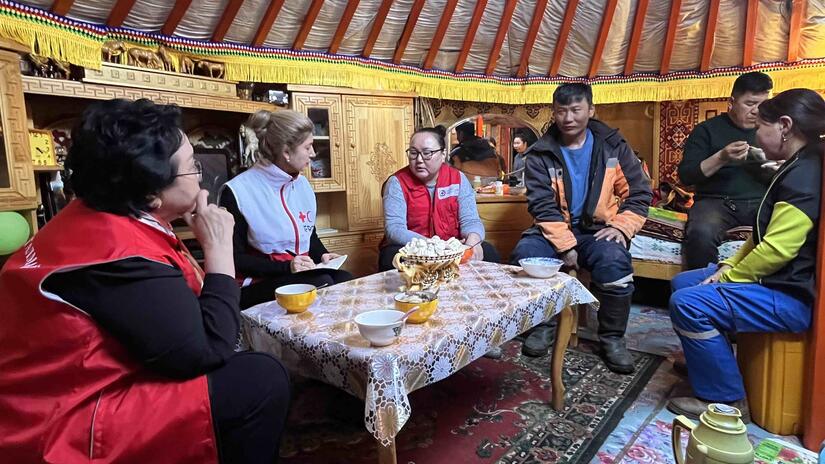 Olga Dzhumaeva (second from left), head of IFRC's East Asia Delegation, joins the Mongolian Red Cross in a meeting with Tumurzurkh S., a herder from Dornod province who explains how extreme and cold have impacted his family.