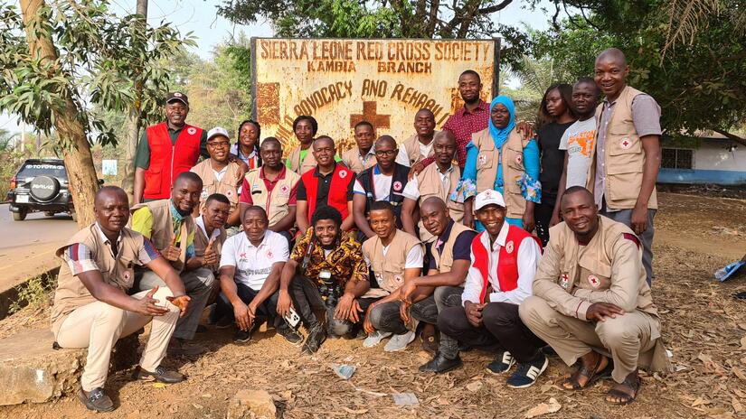 Supervisors and staff from the Community Epidemic and Pandemic Preparedness Programme in Sierra Leone stand together outside the branch office in Kambia.