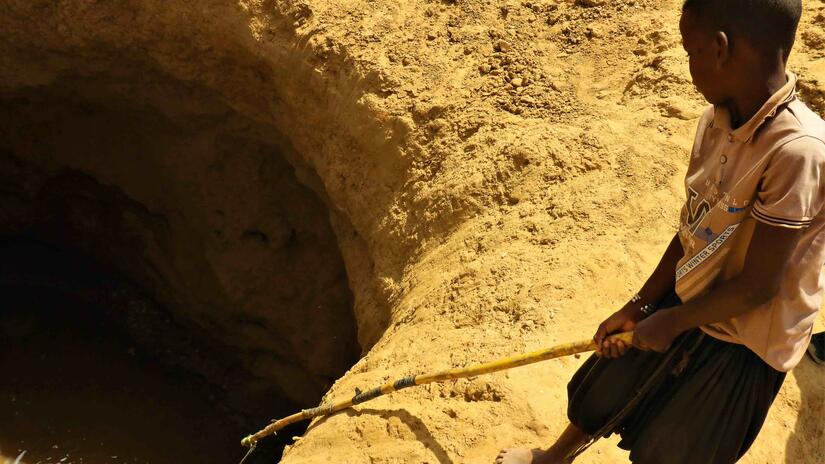A child fletches water from a well in Barkeol, Mauritania. Recent heat waves, credited to climate change, worsen the vulnerabilities faced by argricultural communities due to water shortages and long-term drought.  