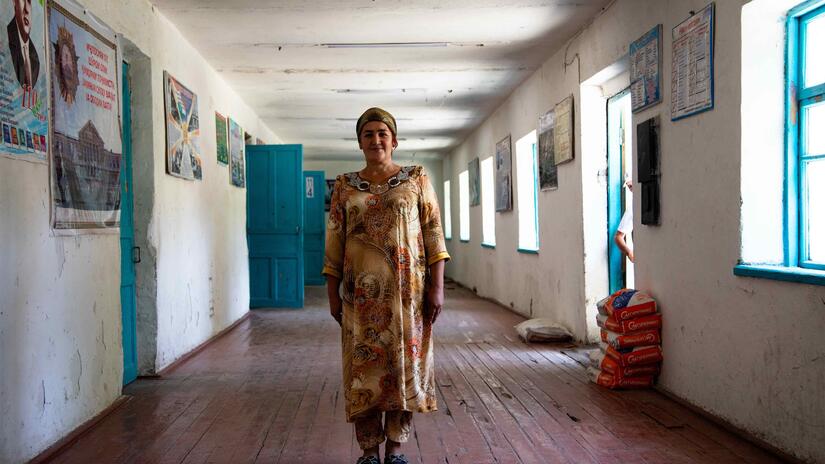 Standing in the hallway of her school, chemistry teacher Saida Meliboeva explains how she and other Tajikistan Red Crescent volunteers warn children to stay away from landmines and other dangers in the border area between Tajikistan and Uzbekistan.