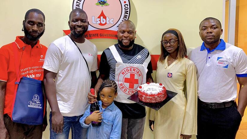 Ademola Gafarr (center) is joined by one of his three children, friends and Red Cross colleagues for his recent birthday, blood-donation celebration.