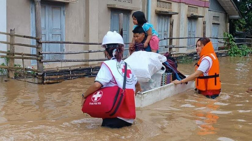 Volunteers from the Myanmar Red Cross mobilize to help people displaced from an urban neighbourhood by severe flooding.