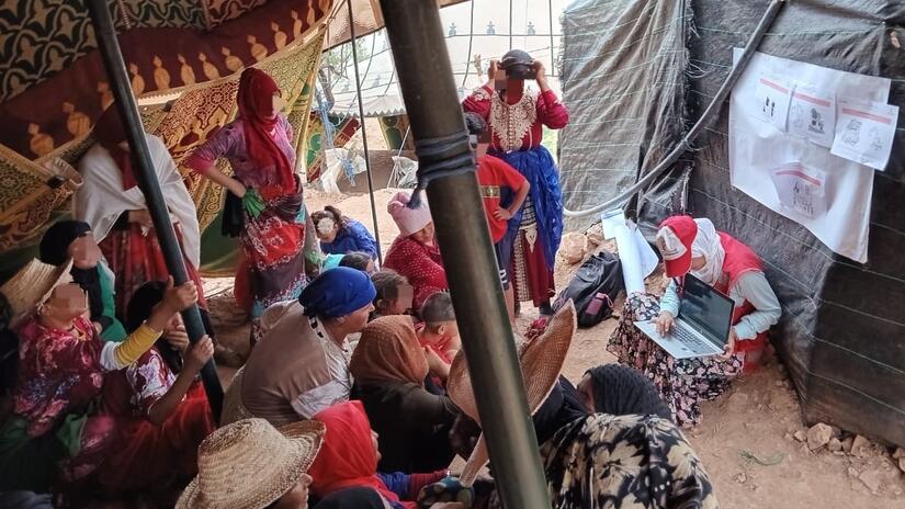 Naima offers a presentation of the temporary shelter programme and selection criteria to women of the community of Tighoula.