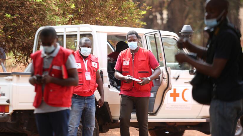 Dr. Aimé Mbonda, regional IFRC Health Coordinator based in Yaoundé, Cameroon, makes a community visit with volunteers during the Covid-19 pandemic.