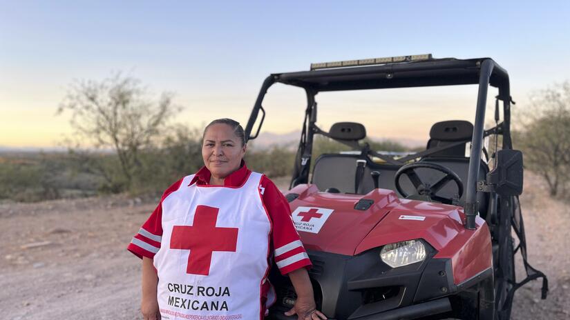 Rosa Guadalupe Gonzales Bucioto, known locally as Lupita, in front of her Mexican Red Cross all-terrain vehicle in the Sonoran Desert along the southern side of the US-Mexican border.