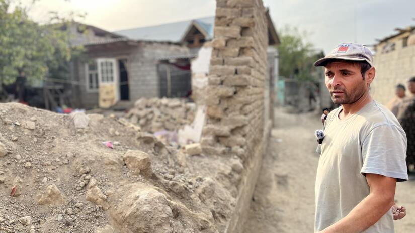 In the Roma village in Osh, Kyrgyzstan, a man stands next to what is left of his home. Made from traditional clay bricks, his house was washed away after a nearby river flooded the village in July, destroying and damaging many homes.