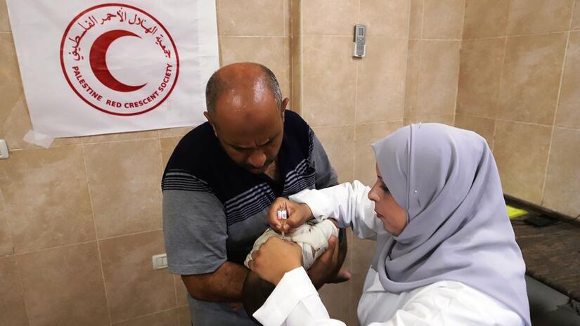 Palestine Red Crescent Society staff and volunteers vaccinate children in the Gaza Strip against Poliovirus.