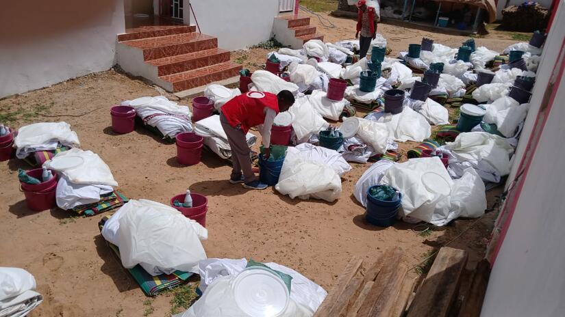 A volunteer with the Mauritanian Red Crescent prepares packages to be distributed to people from Mali who came to Mauritania to find safety from internal fighting in Mali.