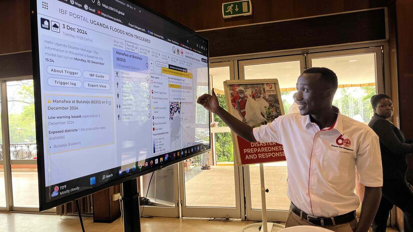 Emmanuel Ntale, the Anticipatory Action focal point of Uganda Red Cross Society, analyses the data provided in the Impact-Based Forecasting Portal, using weather forecasts to predict and reduce the worst impacts of climate events such as floods.