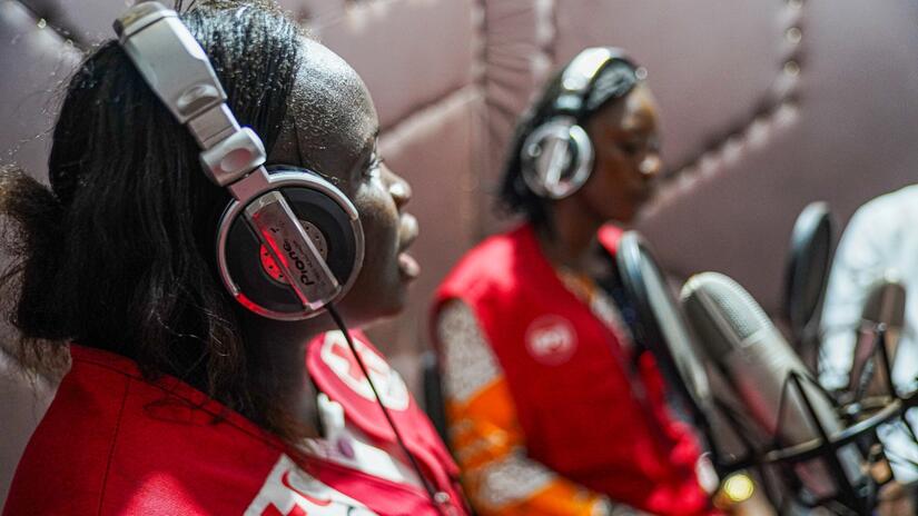 Staff member, Esther, and volunteer, Gloria, from the DRC Red Cross share mpox information during a radio broadcast on Radio Soleil Couchant in Équateur in July 2024.